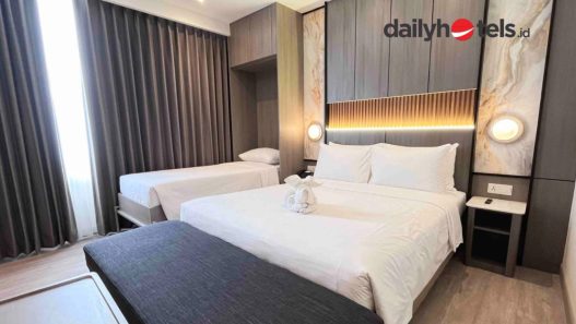 A modern hotel room featuring a Murphy bed (wall bed) that is partially folded or integrated into the wall to save space, showcasing a clean and functional interior design.